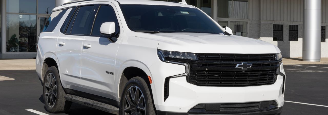 A happy customer driving their newly purchased used SUV from a dealership in Mansfield, OH.