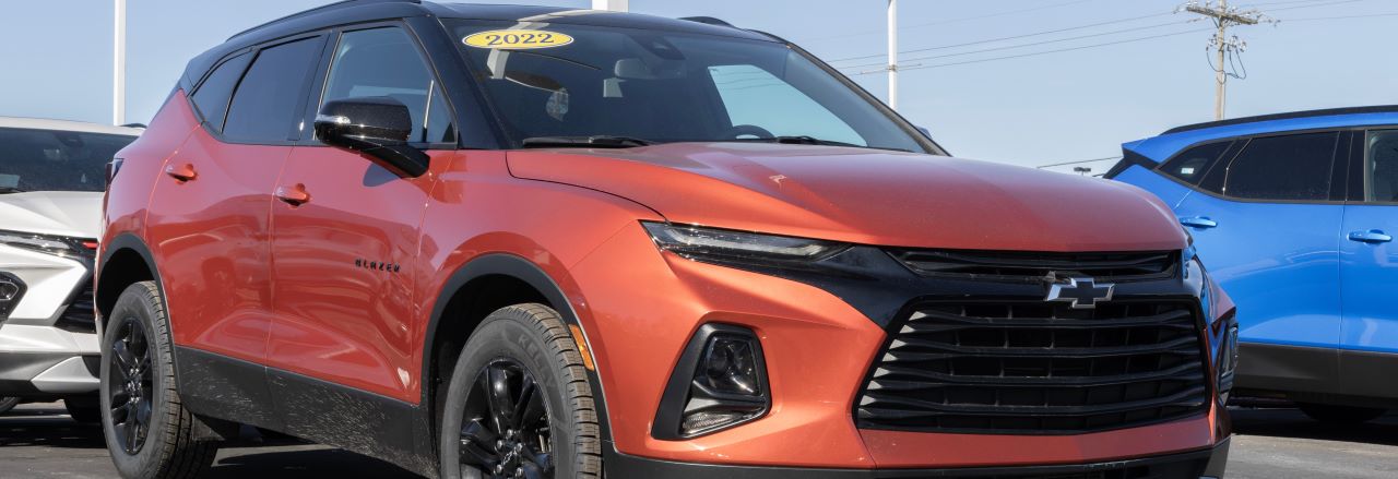 A sleek, pre-owned SUV in front of Hall's Auto Sales, showcasing affordability and reliability.
