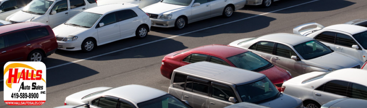 Inventory lot at Hall’s Auto Sales in Mansfield, OH, showing a variety of clean, pre-owned cars and trucks.
