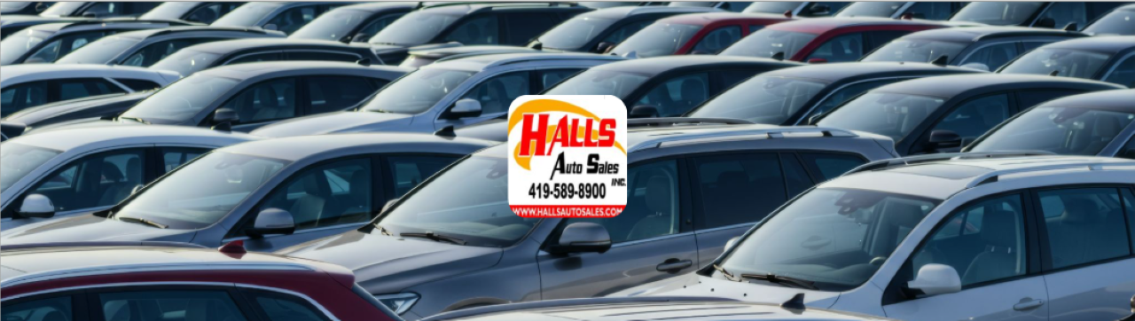 Customer shaking hands at Hall’s Auto Sales after receiving their car’s trade-in value in Mansfield, OH.