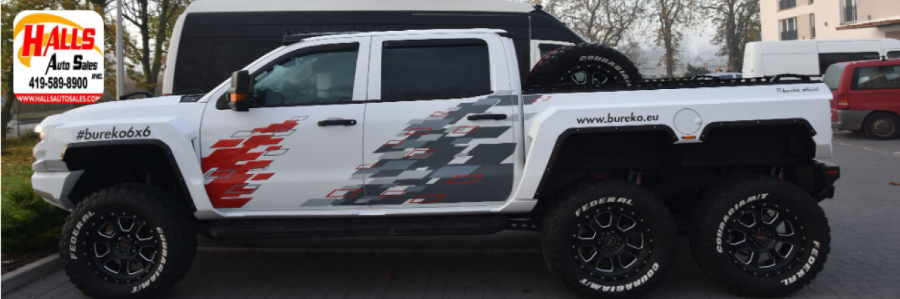  Row of used trucks and SUVs available at Hall’s Auto Sales in Mansfield, Ohio.