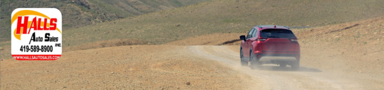 Customer off-roading in a pre-owned SUV bought from Hall’s Auto Sales, highlighting the quality and value offered by local dealers in Mansfield.
