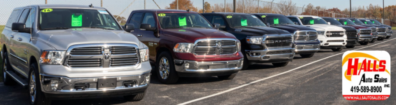 A row of used trucks on the Hall’s Auto Sales lot in Mansfield, OH, is ready for local buyers seeking durability and performance.